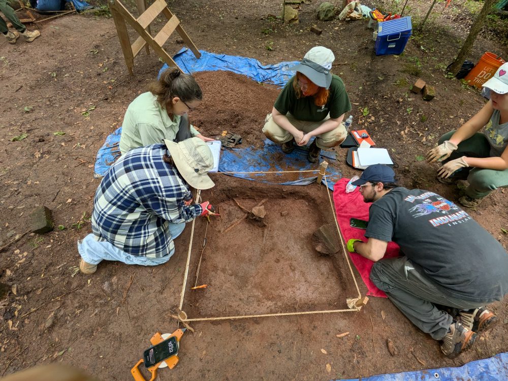 Several students working on excavating an archaeological site